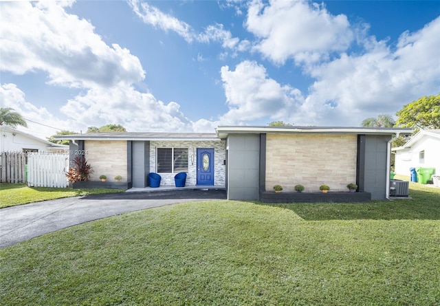 ranch-style home featuring a front yard and central AC