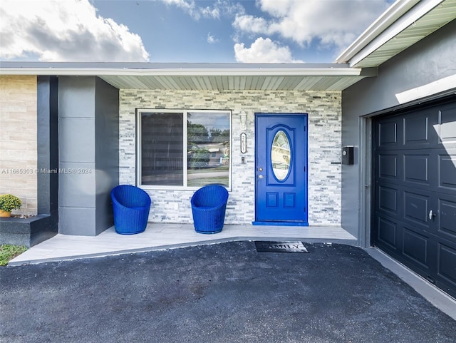 view of exterior entry with a garage