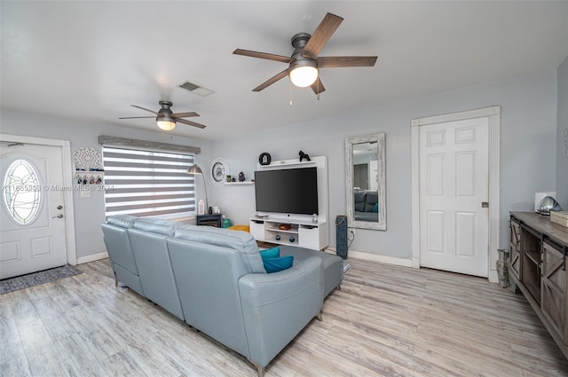 living room featuring ceiling fan and light hardwood / wood-style flooring