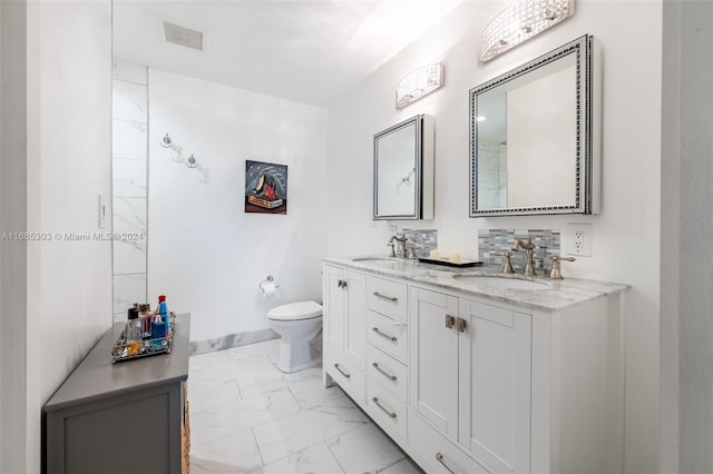 bathroom featuring toilet and vanity