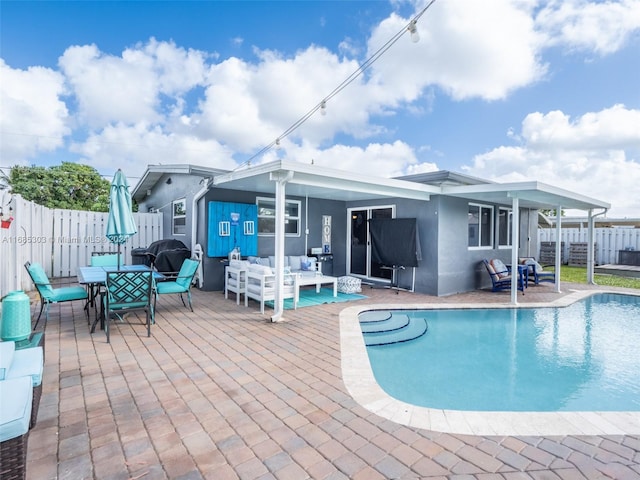 rear view of house featuring a fenced in pool, a patio, and an outdoor hangout area