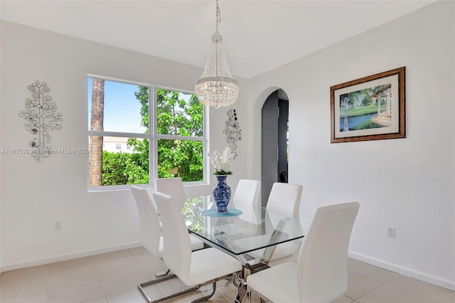 dining space with light tile patterned floors and a chandelier