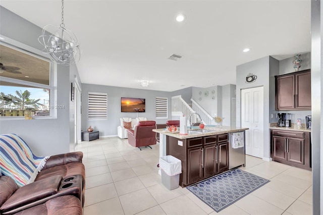 kitchen with sink, a center island with sink, a notable chandelier, dishwasher, and hanging light fixtures