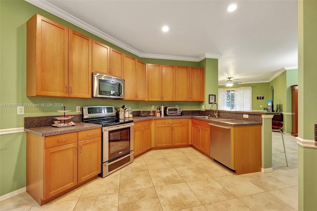 kitchen featuring ceiling fan, stainless steel appliances, ornamental molding, and light tile patterned flooring