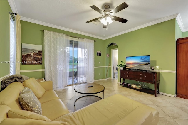 tiled living room with crown molding and ceiling fan