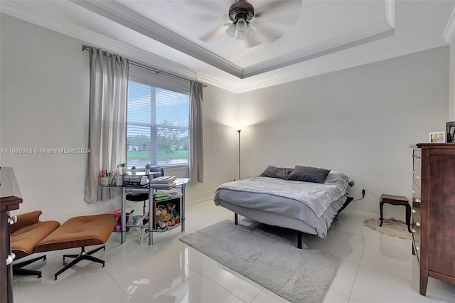 bedroom featuring ceiling fan, ornamental molding, a tray ceiling, and light tile patterned floors