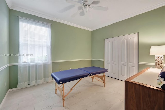 rec room with crown molding, light tile patterned floors, and ceiling fan