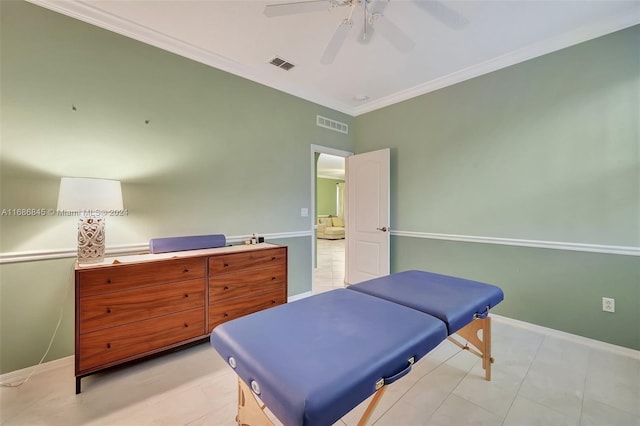 tiled bedroom with ornamental molding and ceiling fan