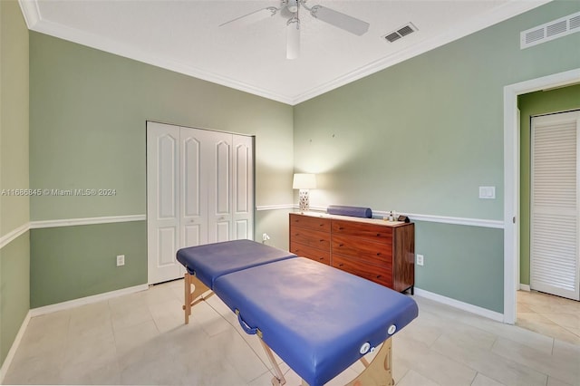 bedroom with light tile patterned floors, crown molding, a closet, and ceiling fan