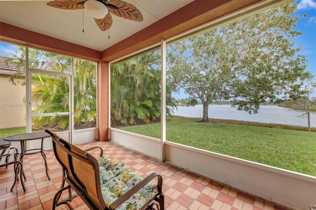 sunroom / solarium with a water view and ceiling fan