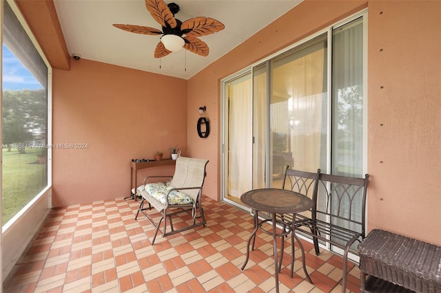 sunroom / solarium featuring ceiling fan