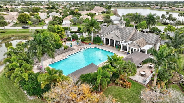 view of pool featuring a water view and a patio