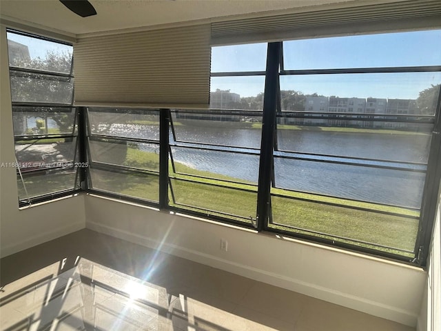 unfurnished sunroom featuring a water view and a wealth of natural light