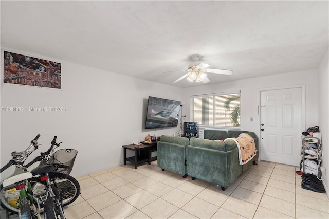 living room with a ceiling fan and light tile patterned flooring