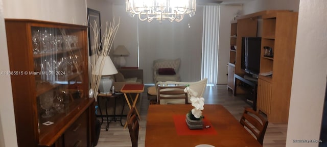 dining space with a notable chandelier and light wood-type flooring