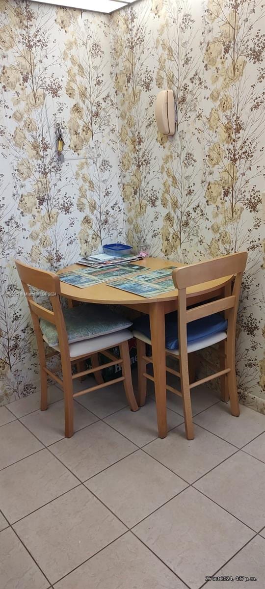 unfurnished dining area featuring tile patterned flooring