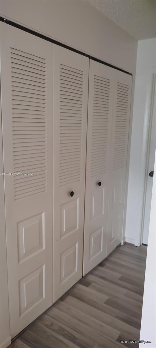 room details with hardwood / wood-style flooring and a textured ceiling