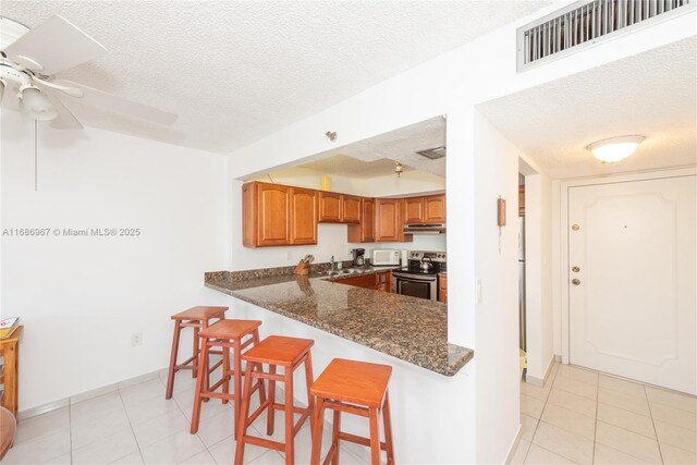 entryway with light tile patterned flooring and plenty of natural light