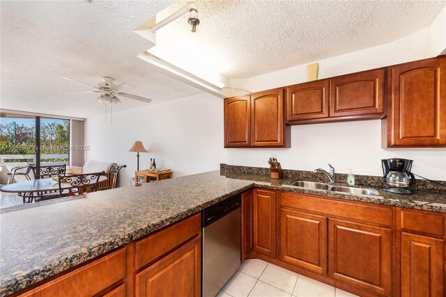 tiled dining space with ceiling fan, sink, and a textured ceiling