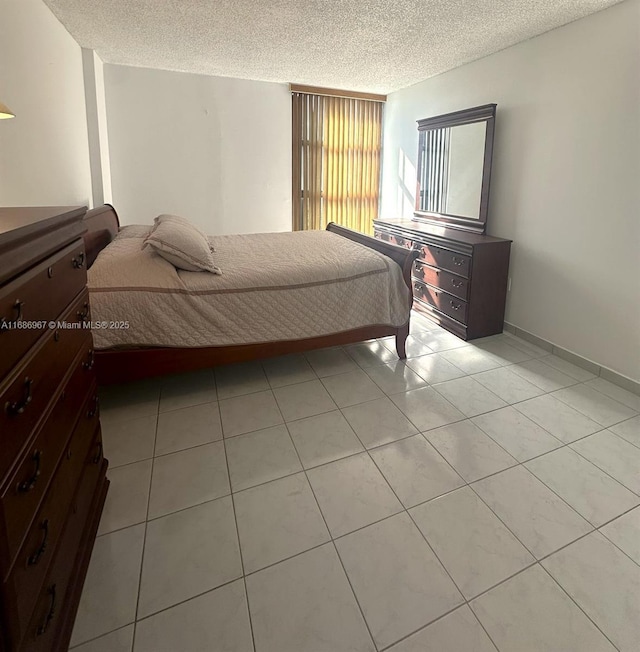 bedroom featuring a textured ceiling and light tile patterned floors