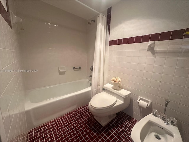 bathroom featuring tile patterned floors, toilet, tile walls, a bidet, and shower / bath combination with curtain