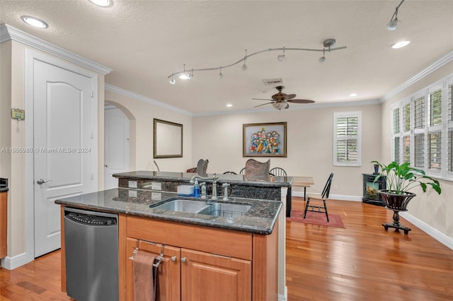 kitchen with stainless steel dishwasher, a textured ceiling, sink, and light wood-type flooring