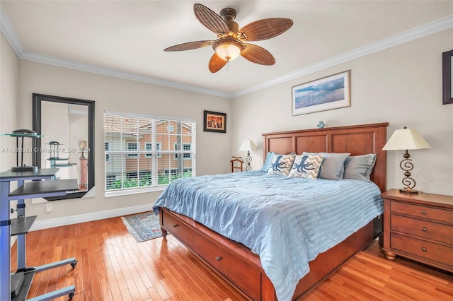 bedroom featuring ceiling fan, ornamental molding, and light wood-type flooring