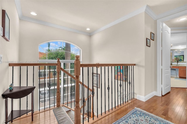 hall with crown molding and light hardwood / wood-style floors