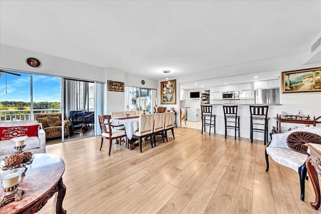 dining space featuring light hardwood / wood-style floors