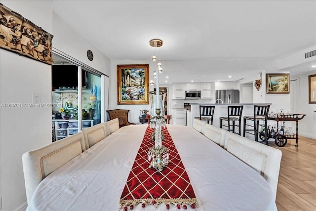 dining area with light hardwood / wood-style floors