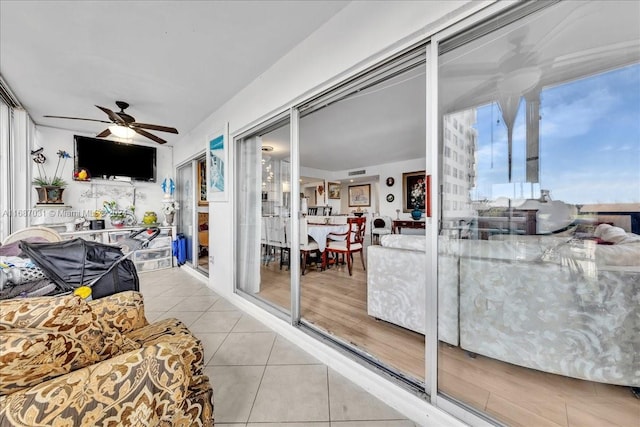 living room with ceiling fan and light wood-type flooring