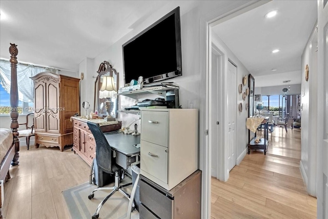 home office with light hardwood / wood-style floors