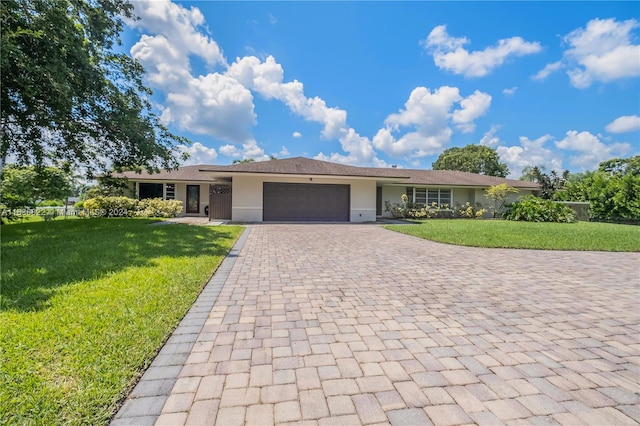 single story home with a garage and a front yard