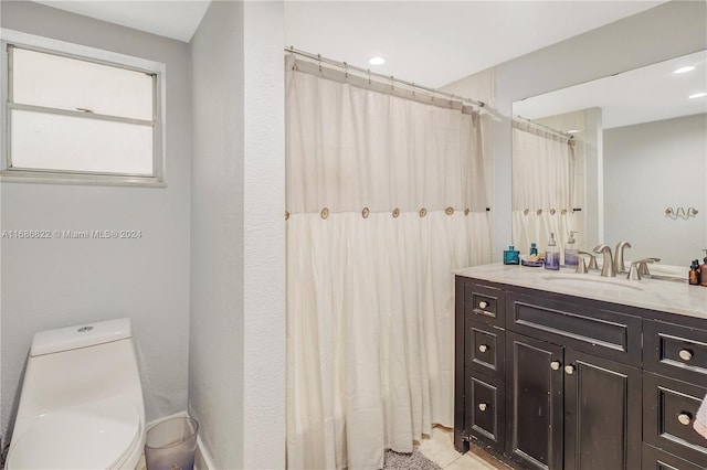 bathroom featuring vanity and toilet