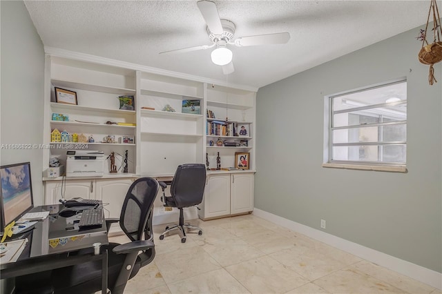 office area with a textured ceiling and ceiling fan