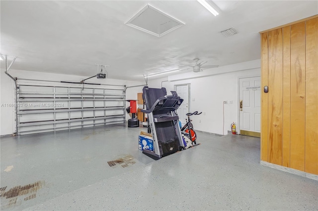 garage with a garage door opener and ceiling fan