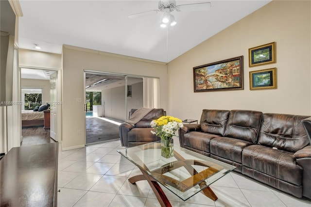 tiled living room with ceiling fan and lofted ceiling