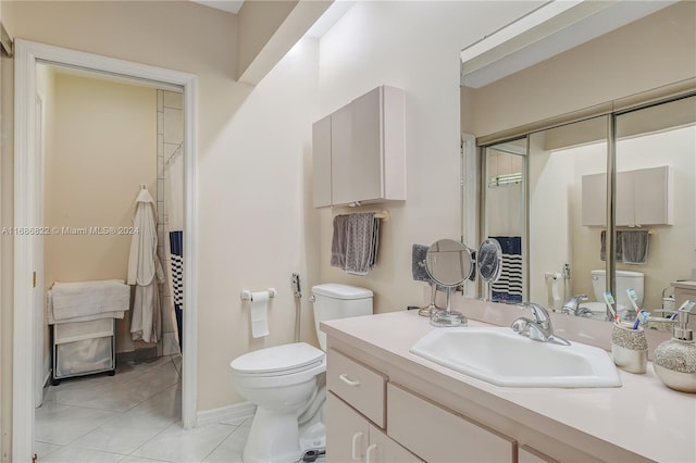 bathroom featuring tile patterned flooring, vanity, and toilet