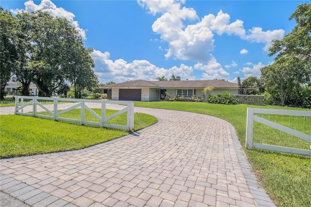 ranch-style home featuring a garage and a front lawn