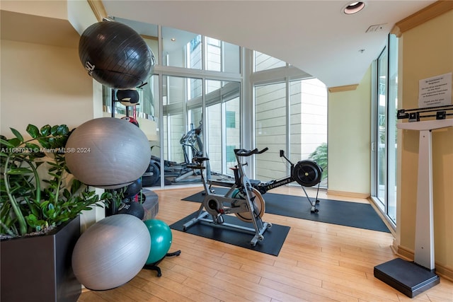 workout room featuring light wood-type flooring