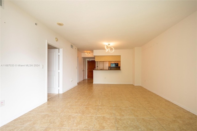 unfurnished living room featuring light tile patterned floors