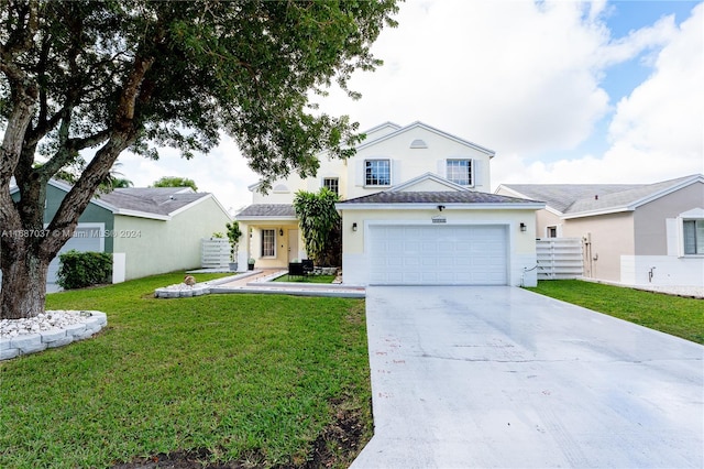 view of front of home featuring a front yard and a garage