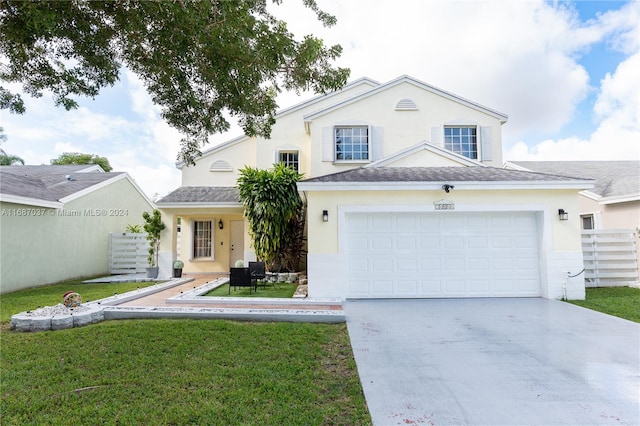 view of front property featuring a front yard and a garage