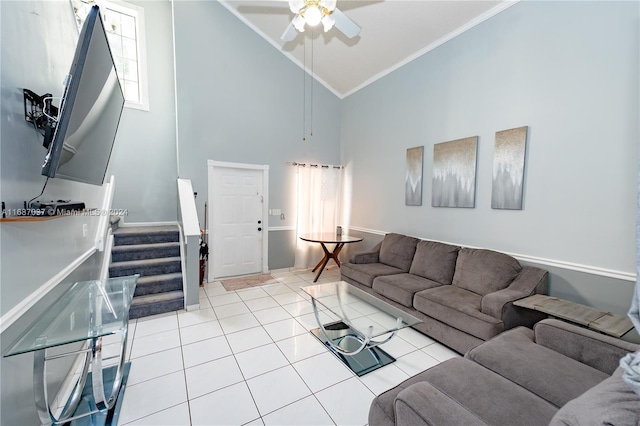 living room with ornamental molding, light tile patterned floors, high vaulted ceiling, and ceiling fan