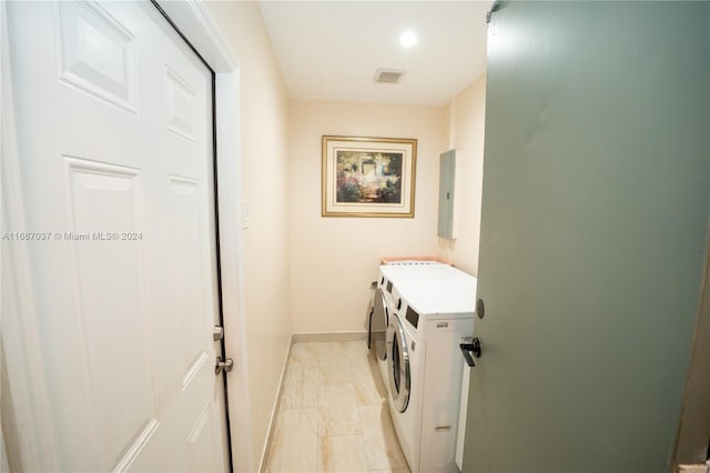 laundry room with washer and dryer and electric panel