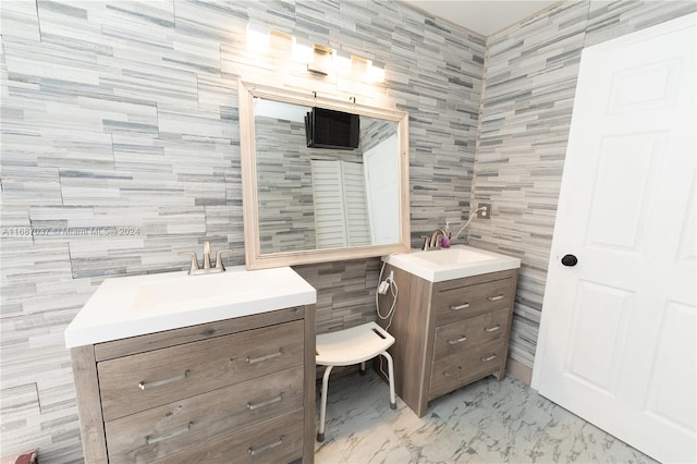 bathroom with vanity and tile walls