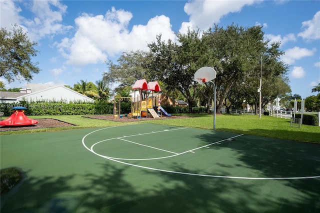 view of basketball court with a lawn and a playground