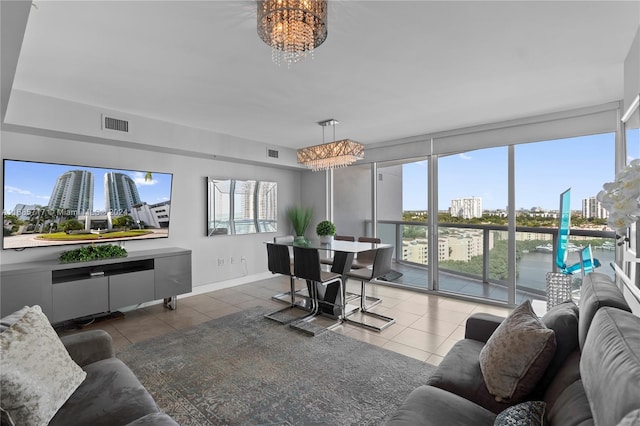 living room featuring a chandelier and dark tile patterned flooring