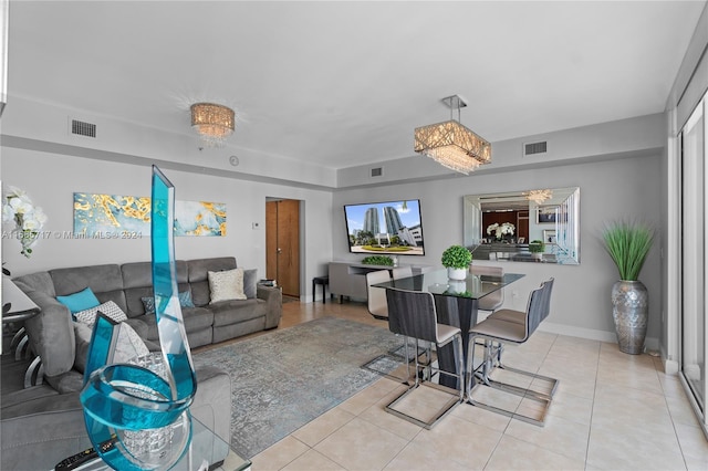 living room featuring light tile patterned floors and a notable chandelier