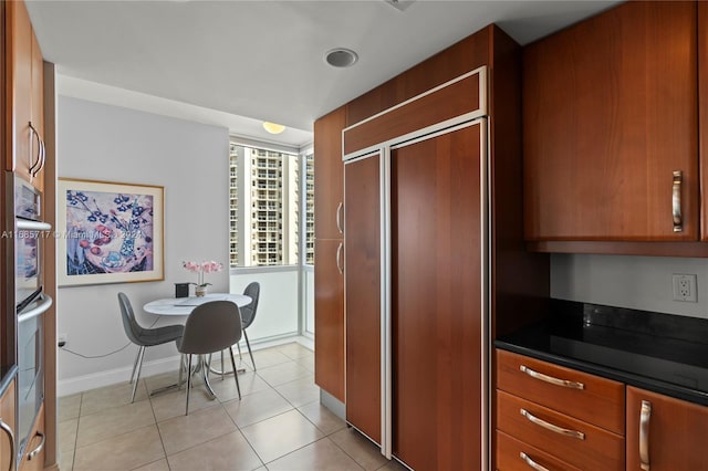 kitchen featuring paneled built in refrigerator and light tile patterned floors